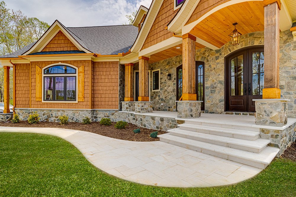 Battaglia West custom home exterior in Western Maryland featuring a beautifully crafted front façade enriched by premium wood finishes, showcasing luxury craftsmanship and timeless architectural details.